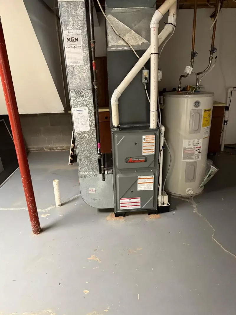 Indoor furnace and coil connected to a new central AC system in a Fairport, NY 14450 home, installed by MGM Heating & Cooling.