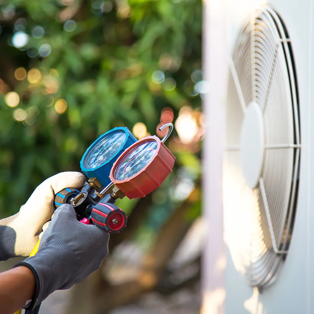 Experienced HVAC Technicians – MGM Heating & Cooling HVAC technician checking refrigerant gauges on outdoor AC unit
