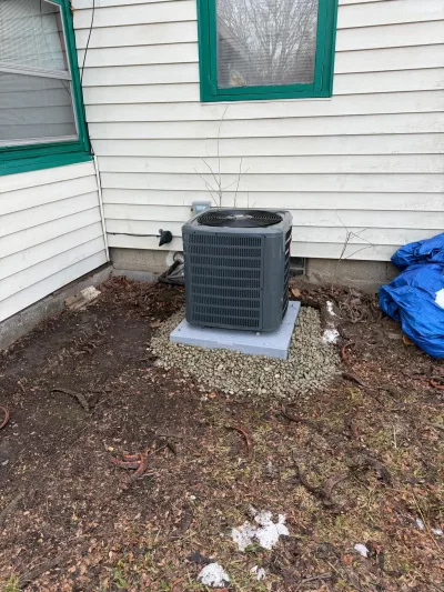 Central air conditioner installation on pad in Rochester NY by MGM Heating and Cooling